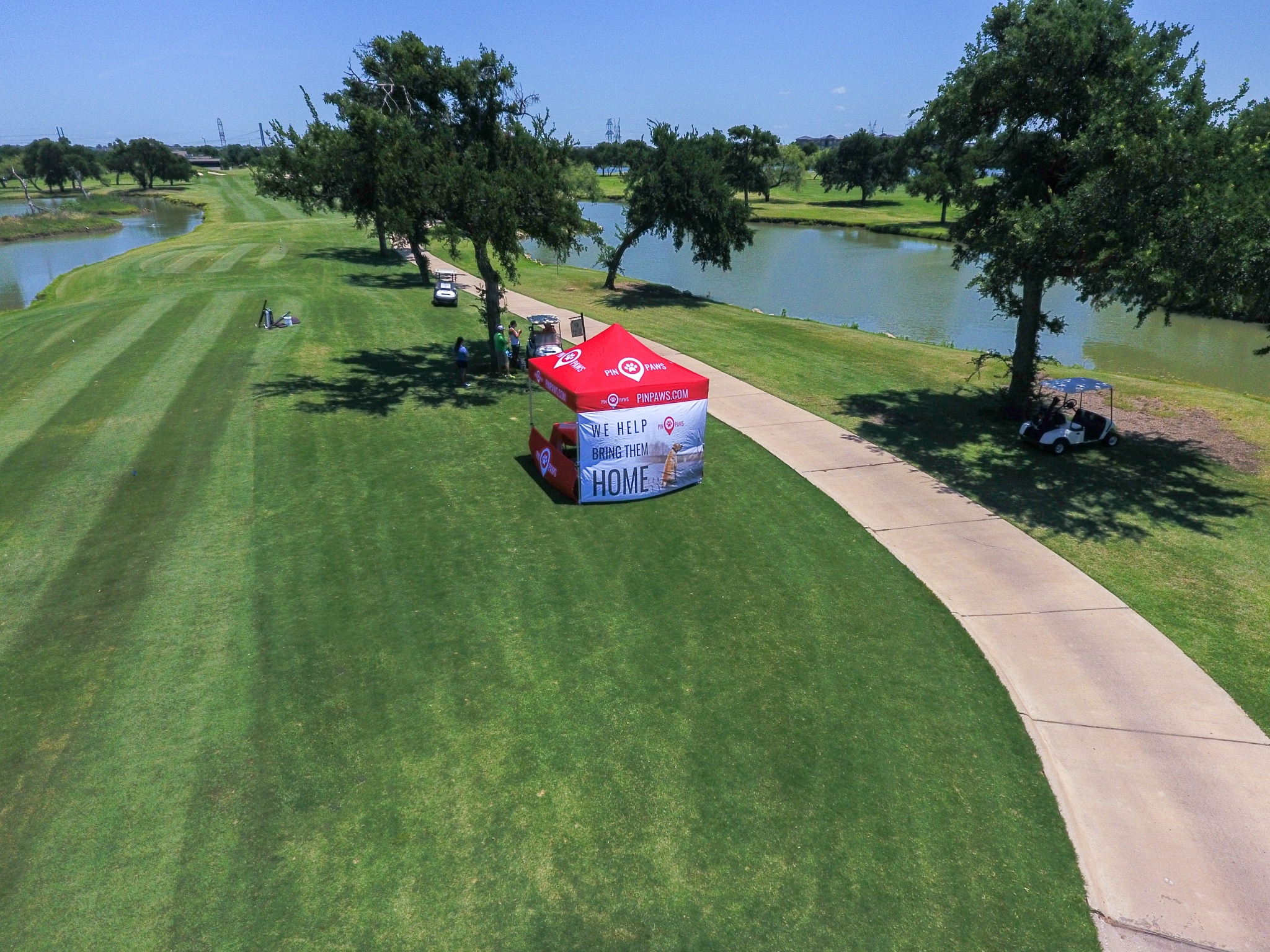 Drone photo over HRC tournament with Pin Paws booth hosting shot gun golf hole